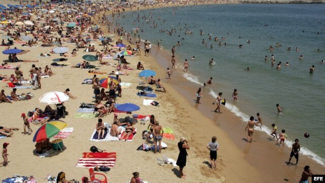 Fotografía de archivo de numerosos bañistas en la playa del Bogatell, Barcelona. 