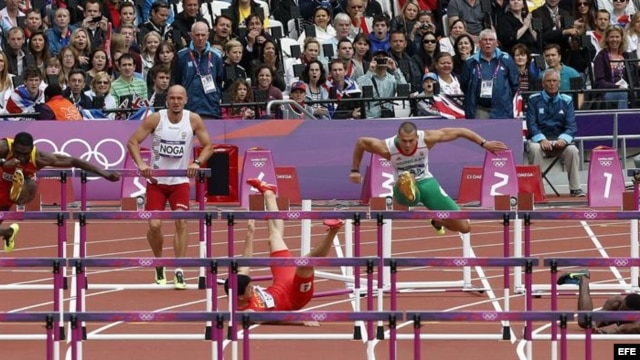 El chino Xiang Liu (c) y el barbadense Shane Brathwaite caen al suelo en la serie clasificatoria de los 110m vallas, en los Juegos Olímpicos de Londres hoy, 7 de agosto de 2012. EFE/Alberto Estévez
