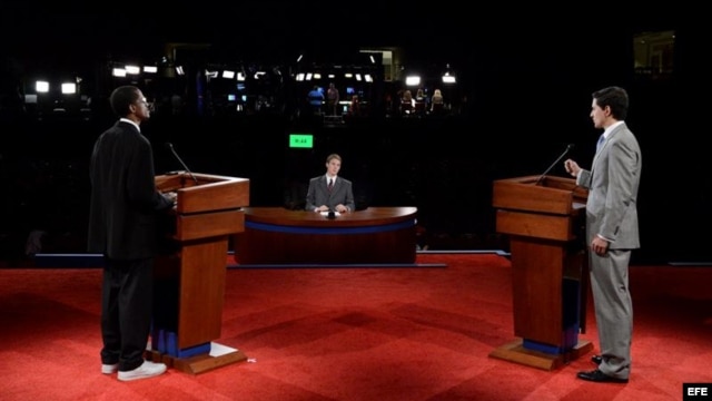 Dos personas en los atriles del escenario simulan el debate presidencial entre el republicano Mitt Romney (d) y el demócrata Barack Obama (i) en la Universidad de Denver, Colorado.