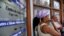 Cubanos esperan a usar una sala de navegación de Internet