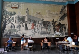 Varias personas son atendidas en una oficina municipal de trabajo. Los cubanos han acudido a las oficinas para preguntar por información sobre el empleo privado.