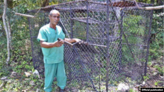 Ángel Cordero (Pachi) y la jaula trampa con la que atrapó los monos verdes.