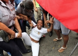 Yaquelin Boni, de las Damas de Blanco es detenida, entre hostigamiento e insultos de sectores oficialistas el 10 de diciembre de 2015, en La Habana (Cuba).