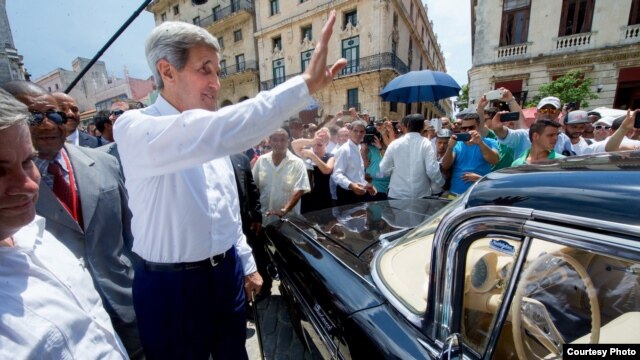 Kerry saluda a los cubanos antes de montarse en un viejo Chevrolet Impala en La Habana.