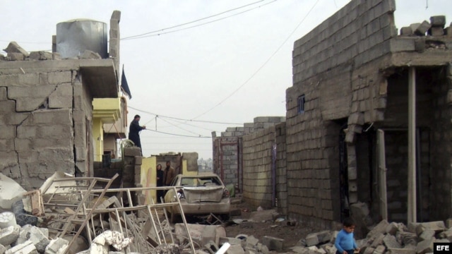 Un niño iraquí camina entre los escombros producidos por un ataque con coche bomba en pueblo de Tahraua, al este de Mosul, en Irak. Archivo.