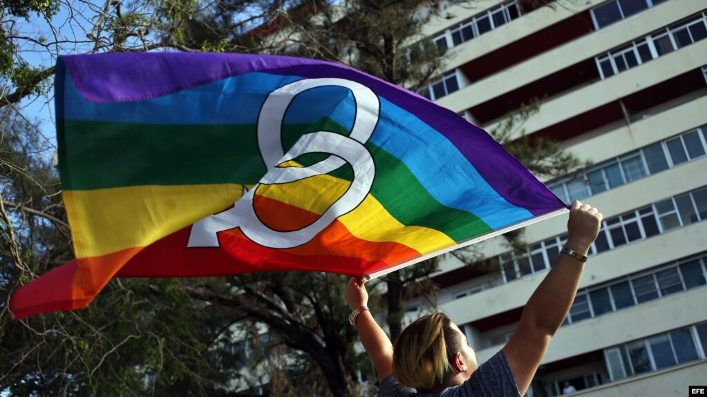 Un hombre ondea la bandera arcoíris durante la Conga Cubana Contra la Homofobia.